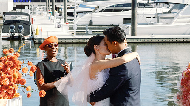 Elegant wedding style shoot with officiant Starlene, featuring a stunning waterfront backdrop with yachts behind the couple