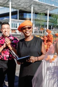 Black award-winning DC wedding officiant Starlene in a styled shoot by The Knot at the scenic DC Wharf, creating a beautifully curated ceremony experience.