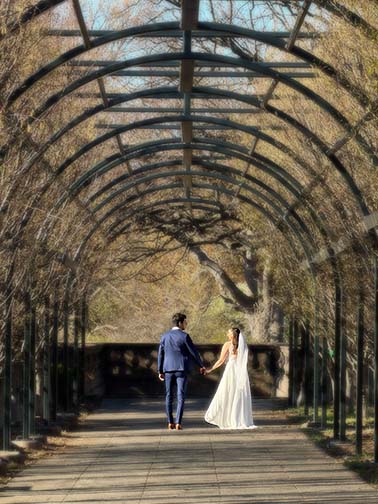 Clement and Laura exiting together after their tiny DC wedding in park with family and friends, capturing a quiet, intimate moment surrounded by nature.